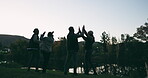 Night, jump and friends in celebration while camping happy for party by the lake together in forest or the woods. Winning, high five and silhouette of excited group of people on vacation in sunset