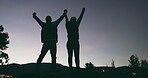 Night sky, couple and silhouette with arms raised outdoor in nature with love for travel, adventure or freedom. Back of man and woman celebrate success on a hill for holiday, vacation or hike in dark