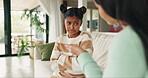 Upset child, mother and talking to discipline bad behaviour, problem or mistake on a home sofa. Sad young girl kid with a woman, parent or family speaking to reprimand, lecture and advice or punish