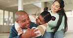 Love, bonding and child hugging her father while relaxing in the living room of their modern house. Happy, smile and girl kid embracing her young parents with care in the lounge of their family home.