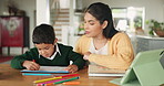 School, work and mom helping child in home, living room or boy with homework, education and learning at table. Student, development and mother teaching math, writing or knowledge to kid with notebook