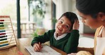 Home, school and mom helping kid with work in home, living room or boy with homework, writing and learning at table. Education, development and mother teaching math, writing to child with notebook