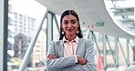 Crossed arms, walking and face of businesswoman in the office with confidence, pride and happiness. Wink, smile and portrait of a professional young female lawyer flirting in a modern workplace.