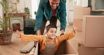 Father, push boy and box in new home for games, car or airplane with smile, bonding and playful with love. Man, young son and cardboard for race, speed and excited with care, moving and family house