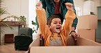 Dad, push son and box in new house for games, car or airplane with smile, bonding and playful with love. Father, boy child and cardboard for race, speed and winner with care, moving and family home