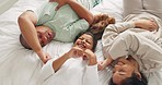 Family, bedroom and fun tickle in morning with laugh and bonding in a home from above. Young girl, parent love and care in a house on bed with mother, father and daughter together with a happy smile