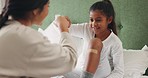 Plaster, fist bump and a mother with her daughter in the home bedroom for injury treatment. Support, motivation or trust with a woman and girl child on the bed for emergency help after an accident