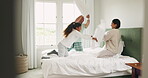 Happy, relax and pillow fight with family in bedroom for playful, morning and love. Happiness, support and funny with parents and child playing in bed at home for games, wake up and excited together