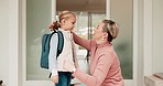 Mother, kid and excited for school with backpack, smile at home and student getting ready at door in morning. Greeting, mom and girl child with bag for learning, development with love and support.