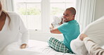 Pillow fight, relax and morning with family in bedroom for playful, happy and love. Happiness, support and funny with parents and child playing in bed at home for games, wake up and excited together