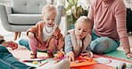 Parents, kids and drawing on living room floor for bonding, teaching and learning together. Color pencil, paper and dad, mom and children in creative play, development and quality time in family home