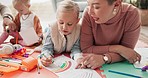 Mom, dad and kids drawing on living room floor for bonding, teaching and learning together. Color pencil, paper and parents with children in creative play, development and quality time in family home