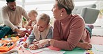 Mom, children and help with drawing on floor of family home for bonding, teaching and learning together. Color pencil, paper and father, mother and kids in creative play, development and quality time