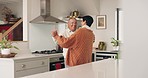 Mature couple, dancing and kitchen with love and marriage in home with music and care. Audio, house and elderly people together with romance and relax in retirement with happy partner and smile