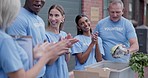 Happy volunteer, donation applause and people celebrate food drive success, nonprofit achievement or charity goals. City community service, excited winner and NGO group clap for social responsibility