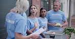 Volunteer group talking, donation and people unpack grocery product, food package or vegetables for community service. Support, communication and non profit team, activist or society for city project