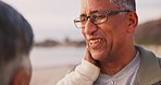 Care, hug and a senior couple at the beach with conversation, date and quality time. Happy, nature and an elderly man and woman with love, communication or support at the sea together to relax