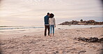 Walking, couple and holding hands on the beach, vacation and holiday to a tropical island for honeymoon or travel with love. Happy, people from the back and walk on sand with happiness in marriage