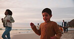 Family, children and a boy running on the beach with his mother during holiday or vacation at sunset. Kids, freedom or travel and a young male child on the sand with his female parent having fun