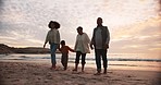 Family, walking on beach with travel and ocean at sunset, people bonding with love and freedom in nature. Grandparents, mother and kid holding hands, journey and adventure with tropical holiday