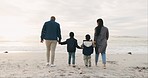 Beach, love and family holding hands and walking together while on holiday, vacation or adventure. Travel, sunset and boy children having fun and bonding with their parents by ocean on weekend trip.