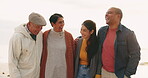 Funny, couple and senior parents at beach for vacation, sea holiday or travel outdoor. Laughing, elderly mother and father with adult man and woman bonding, smile and happy for family time at ocean