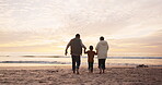 Holding hands, sunset and grandparents with a child at the beach for playing, bonding or a vacation. Back, family and senior man, woman and a kid at the ocean for a holiday at night in summer