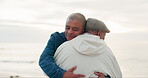 Senior father, man and hug at beach with love, care and bonding on vacation, holiday or travel outdoor at sunset. Elderly dad, adult son and embrace at ocean, sea and happy for family time together