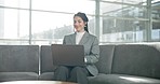 Laptop, sofa and woman in office lobby checking email, networking report or online research. Smile, internet and businesswoman on couch in business lounge with computer typing on review or feedback.