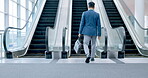 Walking, businessman and escalator in office lobby or entrance to building of work, business or corporate travel. Moving, stairs and man with bag or briefcase in the airport, terminal or tradeshow