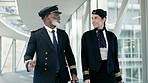 Travel, pilot and air hostess talking at the airport before boarding a flight in the city. Conversation, communication and hospitality air crew team speaking about a strategy in an urban town hotel.