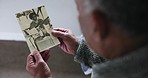 Memory, photograph and old man with retirement, hands and thinking with grief, loss and feeling lonely. Pensioner, vintage picture and elderly person with nostalgia, past and ideas in a nursing home