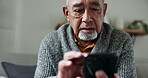 Old man, smartphone and typing, chat and communication, social media and closeup at home. Person using phone, scroll app and internet connectivity, text writing and relax on couch with retirement