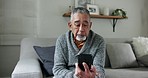 Home, video call and old man on couch, smartphone and connection with hello, greeting and hello. Lounge, pensioner and elderly person on a sofa, cellphone and online communication in a living room