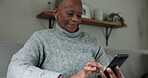 Elderly black woman, smartphone and typing, chat and communication, social media and closeup at home. Using phone, scroll app and internet connectivity, texting and relax on couch with retirement