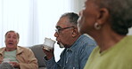 Senior people, friends and drinking tea and talking on sofa or relax together in retirement and social gathering in living room. Elderly, men or woman speaking with coffee and bonding in nursing home