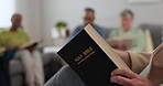 Hand, church and bible for worship, studying God or reading about Jesus for support. House, education and a person with a book for learning about religion, christian help and faith in the gospel