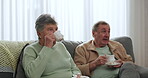 Senior couple, friends and drinking tea and talking on sofa or relax together in retirement and social gathering in living room. Elderly, woman or man speaking with coffee and bonding in nursing home