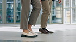 Legs, office and walking business people together for work, professional commitment or collaboration. Floor, corporate and feet or shoes of employees in the workplace for a career or job at a company