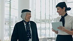 Flight attendant, team and women walking and talking on a conversation at an airport planning schedule. Happy, tablet and travel air hostess or employees speaking about strategy together at terminal