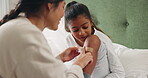 Plaster, knee or accident with a mother and daughter in the bedroom for treatment of a wound or injury. Healthcare, medical and a woman with her girl child to apply an adhesive bandage to a leg