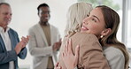 Onboarding, welcome and business women hug for success, achievement and applause by team in office. Support, winning and corporate people clapping hands to celebrate teamwork, love or collaboration 