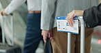 Ticket, travel and immigration queue by people at an airport with luggage for international or global holiday waiting at terminal. Closeup, hands and group in line for a flight for vacation trip