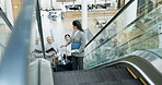 Escalator, talking and a business people with luggage at an airport for travel, holiday or vacation. Professional man and women group moving with a suitcase for flight or at a hotel for convention