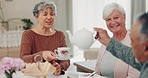 Senior man, women and pouring tea with care, drink and chat in retirement, teacup and smile in house. Elderly group, talk and relax with reunion, coffee and happy at brunch with social event in home