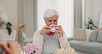 Relax, happy and tea party with old woman in living room for smile, conversation and brunch. Happiness, retirement and friends with senior person drinking in nursing home for lunch, bonding or coffee