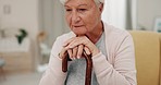 Senior woman, cane and thinking in home with memory, nostalgic and contemplating in a living room. Old person, support and retired female with walking stick relaxing, lost in thoughts and retirement