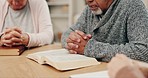 Senior people, bible study and praying together for faith, religion or hope for inspiration or worship in retirement. Elderly friends, holy books or trust for gratitude, spiritual mindfulness or love