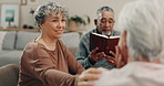 People, support or old woman speaking in bible study with books for praying, praise or mindfulness. Story, learning or Christian faith with senior friends in living room at home for gospel or hope