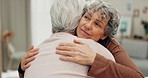 Support, face and senior friends hug in retirement friendship reunion, trust or enjoy time together in home lounge. Kindness, empathy or relax elderly people hugging, comfort and care from old women 